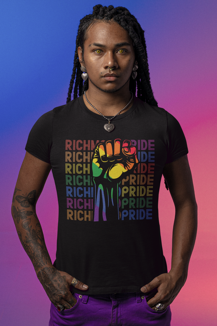 A nonbinary individual with sleeve tattoos wearing a Richmond Pride t-shirt.
