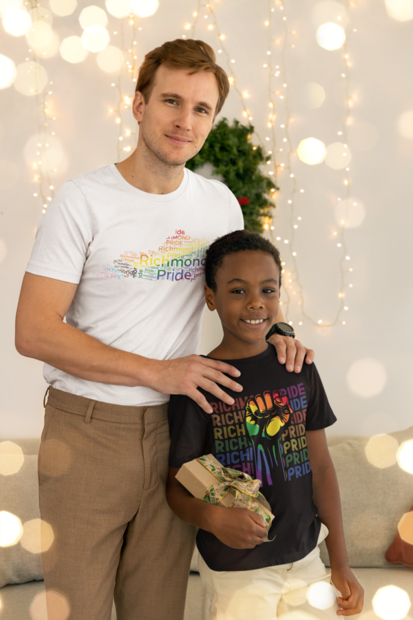 Father an son wearing Richmond Pride shirts. Two teenagers wearing Richmond Pride shirts. One shirt is white with the rainbow flag colors on the state of Kentucky and the other is wearing a the black Richmond Pride shirt with the words Richmond Pride in different colors per row behind a rainbow fist.